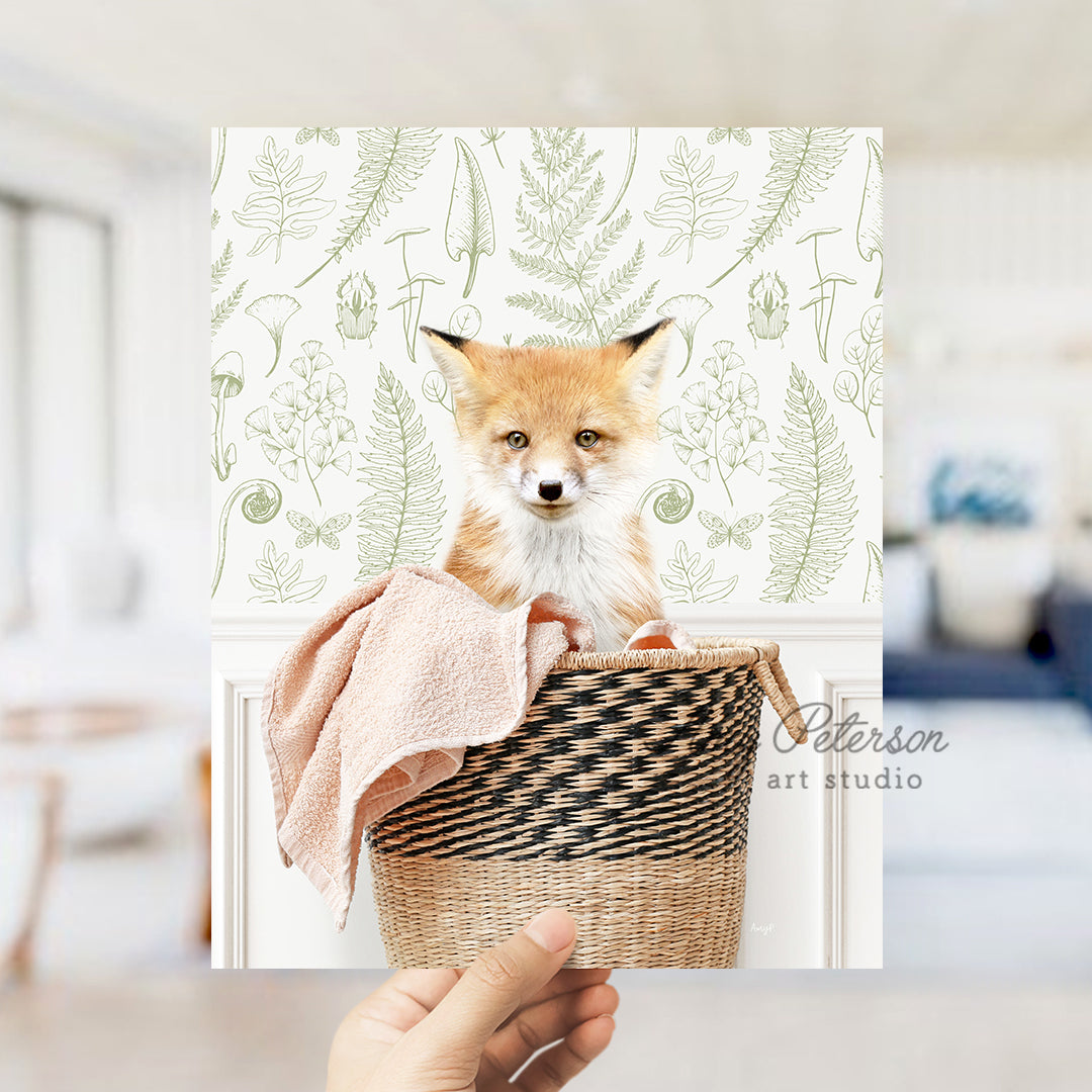 a hand holding a basket with a picture of a fox on it