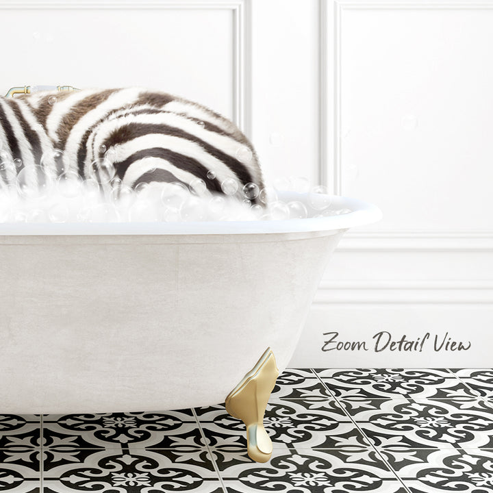 A zebra standing in a white bathtub filled with bubbles, with a black and white patterned floor in the background.