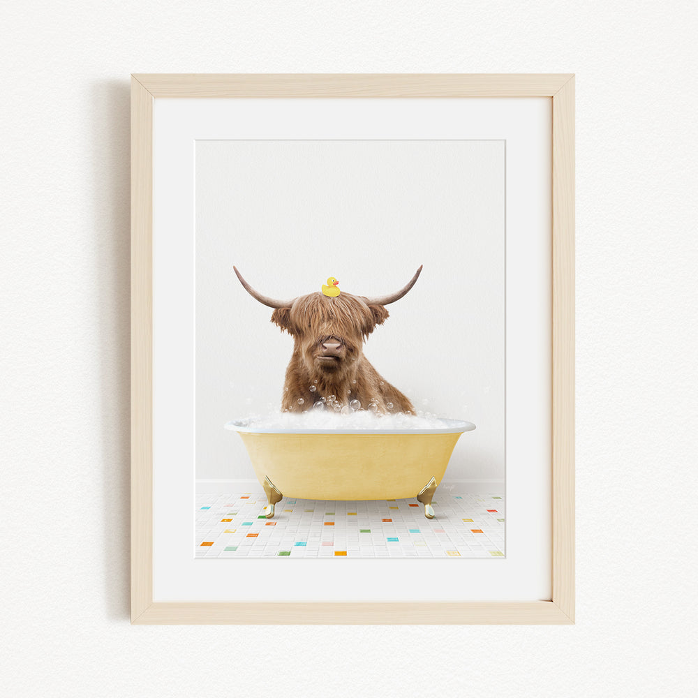 A brown cow with long horns is sitting in a yellow bathtub, with a yellow rubber duck perched on its head.
