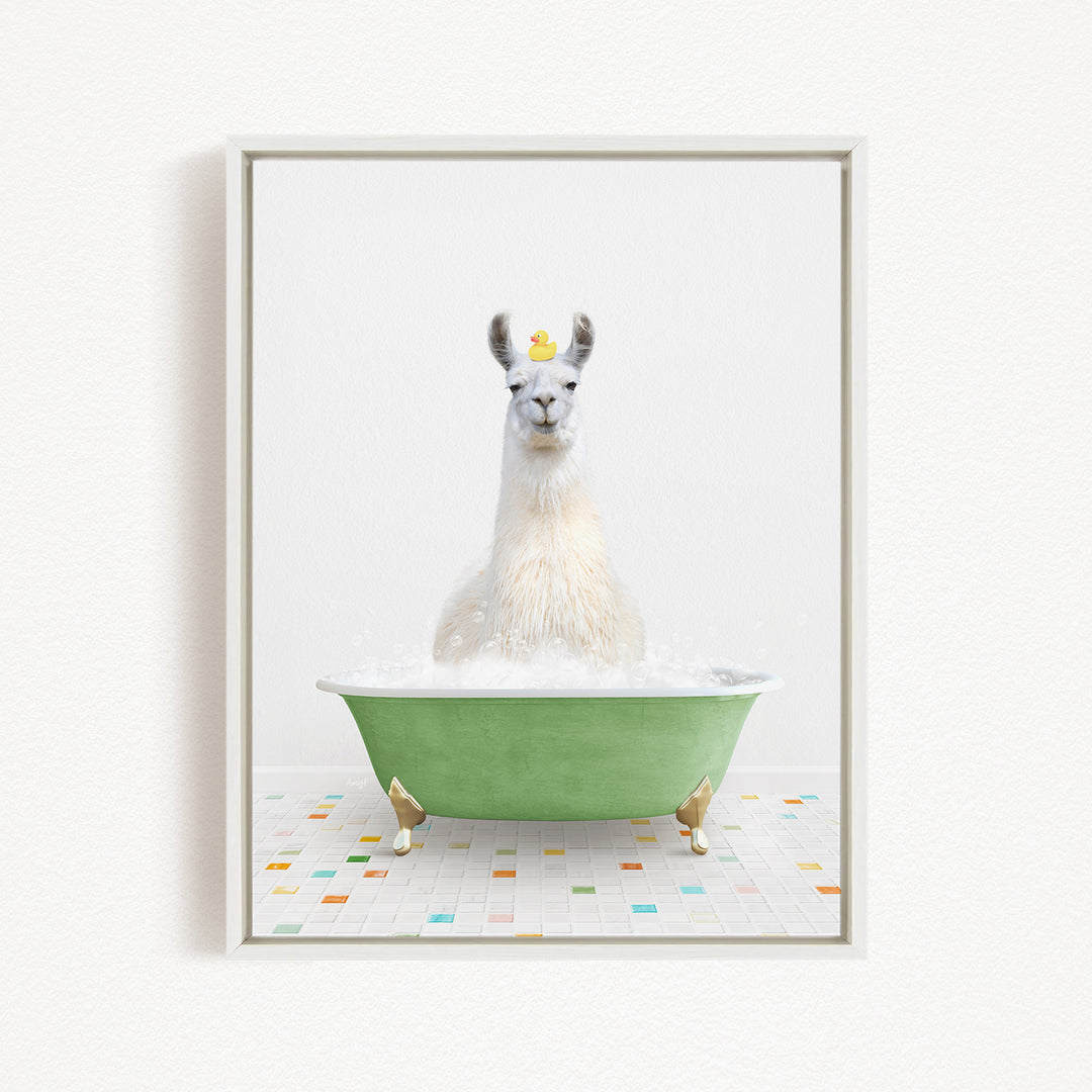 A white llama sitting in a green bathtub filled with bubbles, with a yellow rubber duck floating on its head.