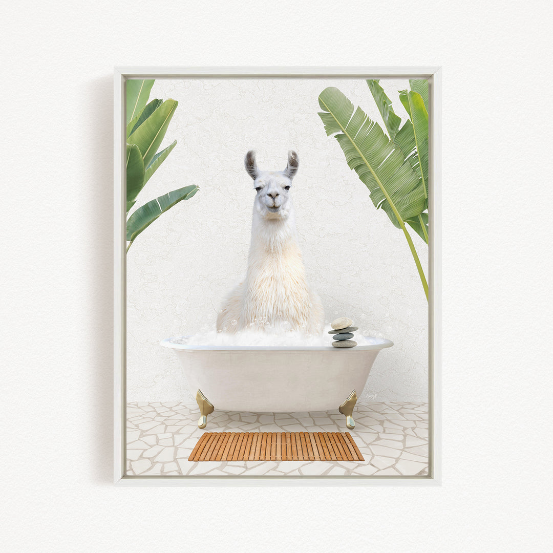 A white llama sitting in a white bathtub filled with bubbles, surrounded by green leaves and a wooden mat on the floor.