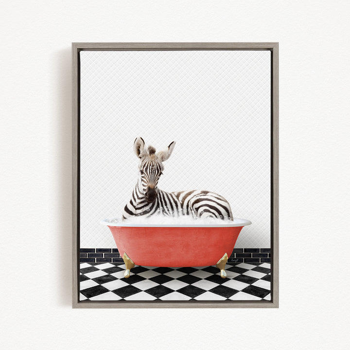 A zebra is sitting in a red bathtub on a black and white checkered floor.
