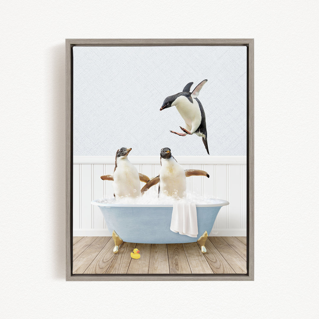 A framed image depicting two penguins sitting in a bathtub, with one penguin flying towards the other penguin.
