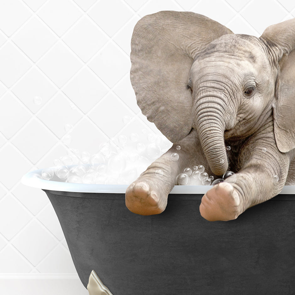 a baby elephant taking a bath in a bathtub