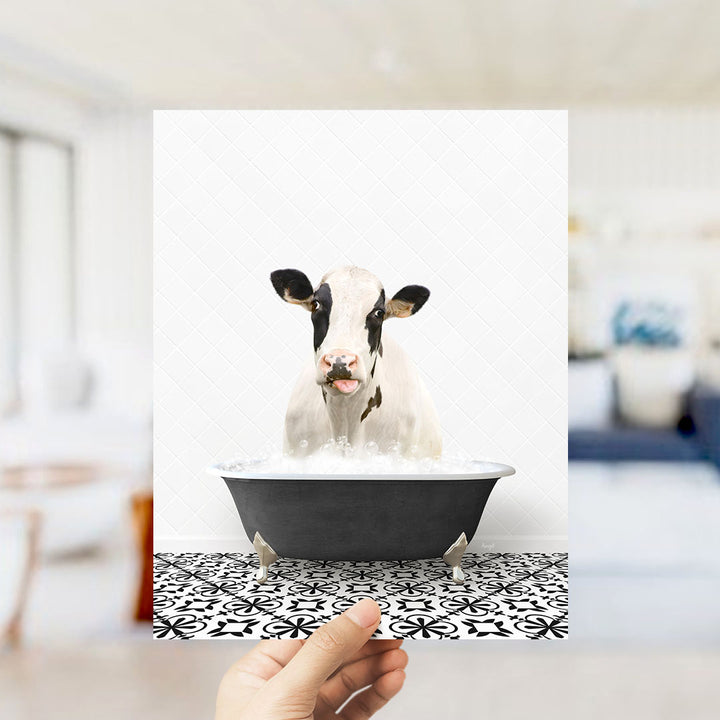 A cow is sitting in a bathtub filled with water, creating a whimsical and humorous scene.