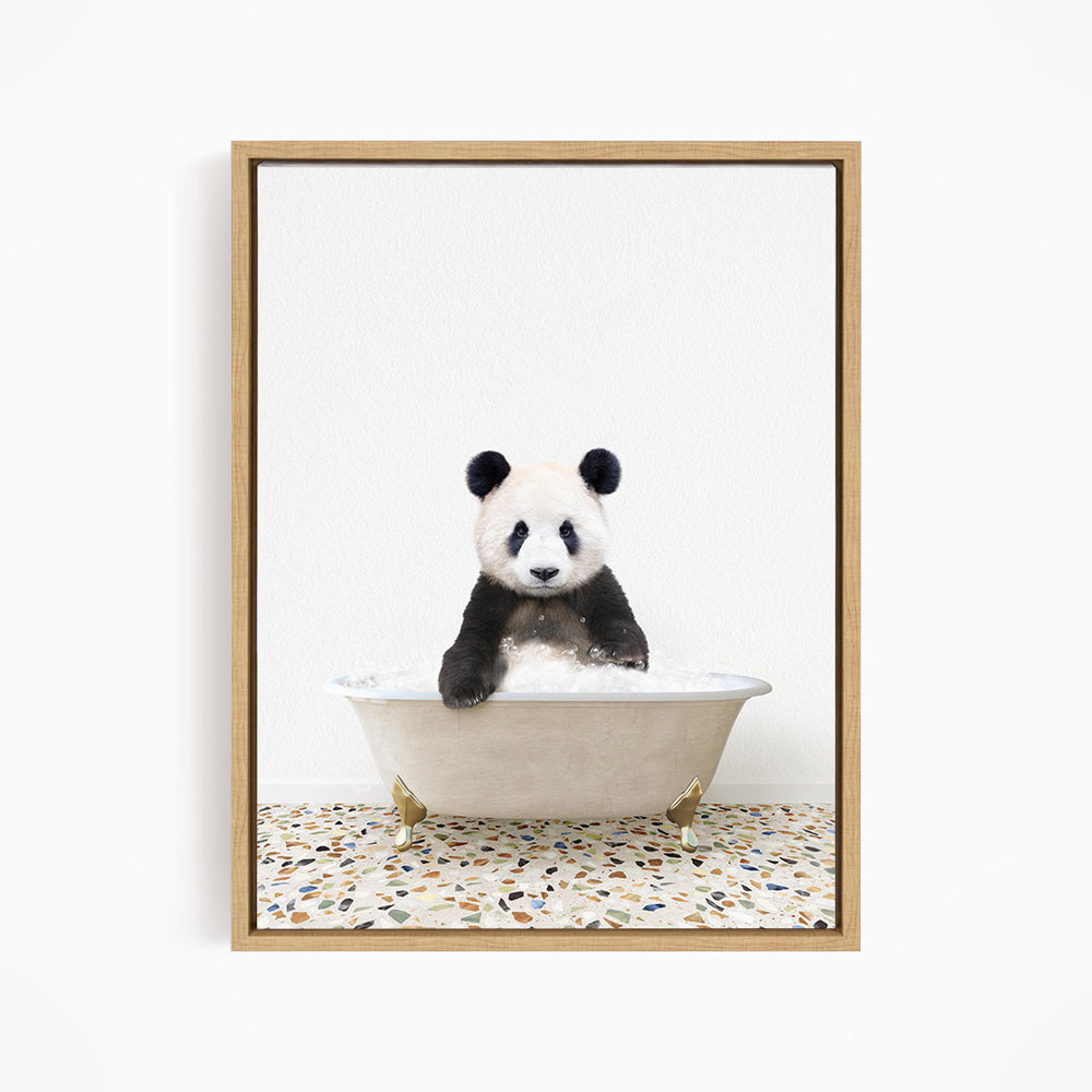 A panda bear sitting in a white bathtub filled with water, looking directly at the camera.