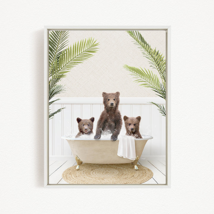 A framed image depicting three brown bears sitting in a bathtub, surrounded by green palm leaves.