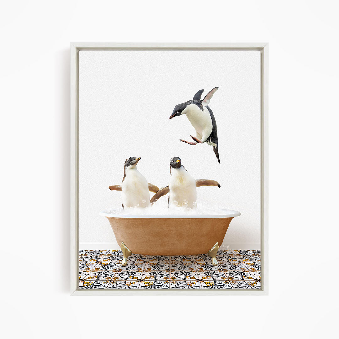A framed image depicting three penguins in a bathtub, with one penguin flying above the tub.