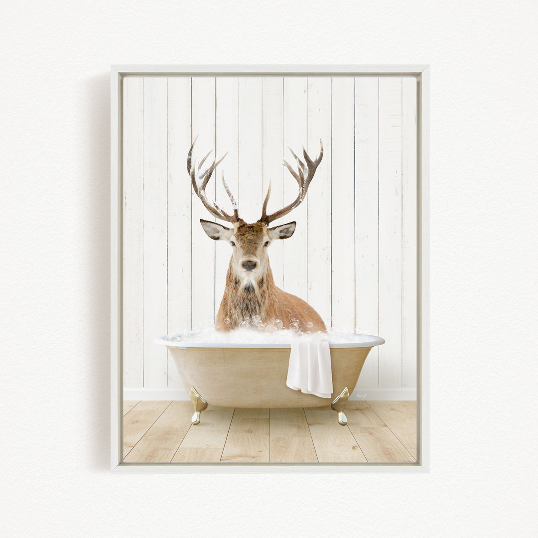 A deer with large antlers is sitting in a bathtub filled with water, creating a whimsical and unexpected scene.