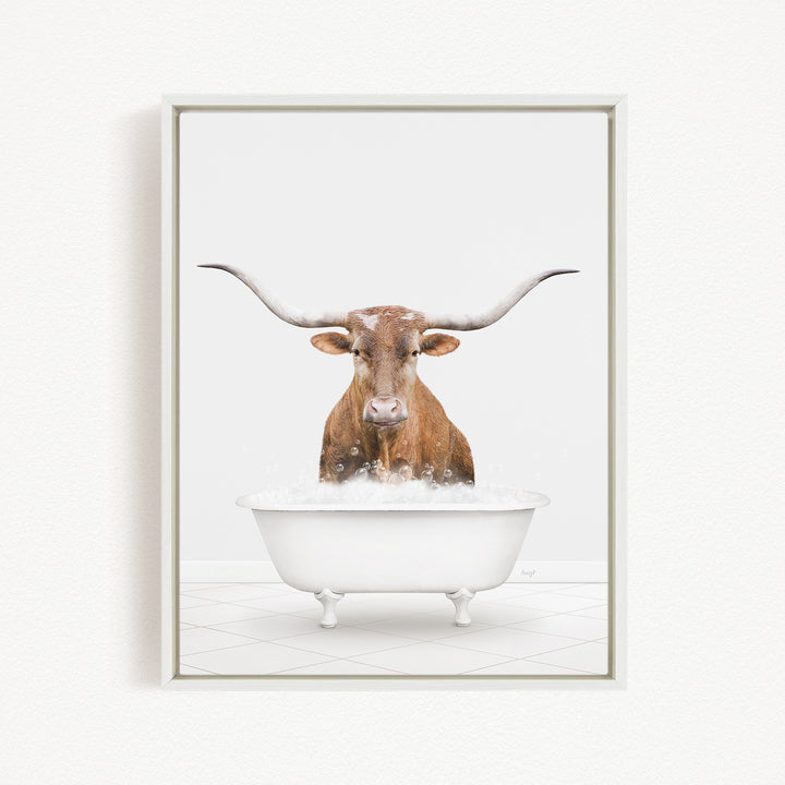 A brown cow with long horns is sitting in a white bathtub filled with water, creating a whimsical and humorous scene.