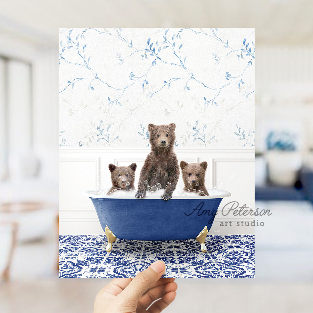 a person holding a card with three bears in a bathtub