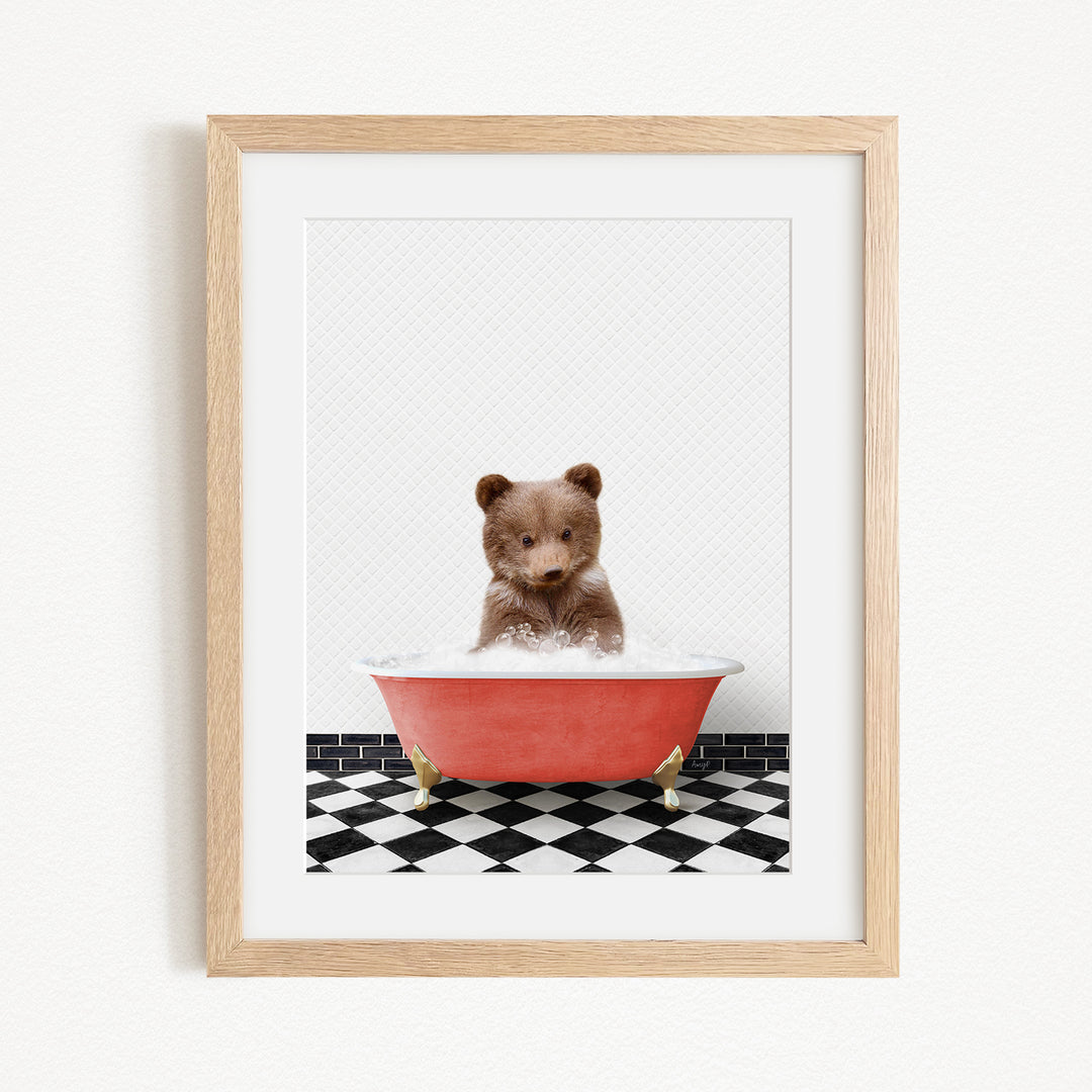 A small brown bear sitting in a red bathtub filled with water, surrounded by a black and white checkered floor.