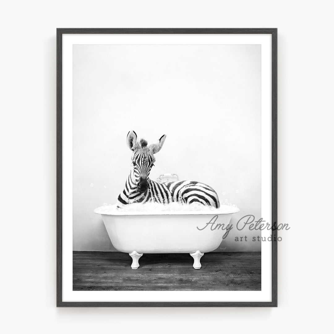 a black and white photo of a zebra in a bathtub