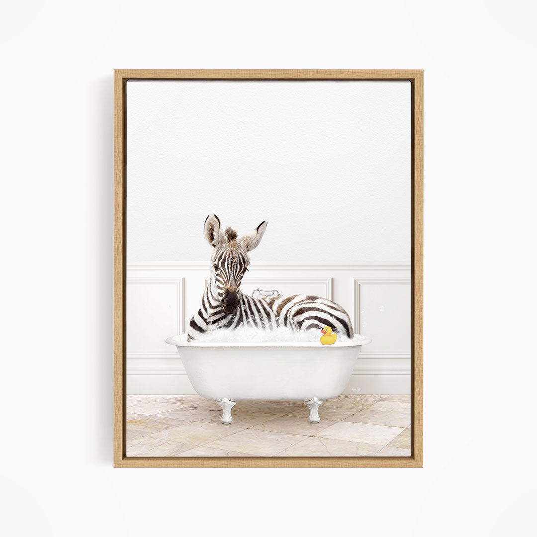 A zebra is sitting in a white bathtub, surrounded by a yellow rubber duck.