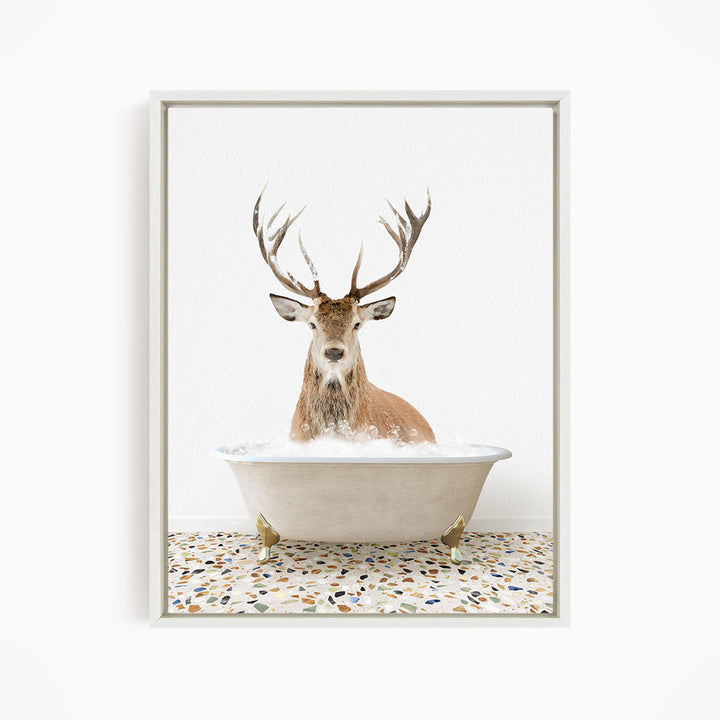 A deer with large antlers is sitting in a bathtub filled with water, creating a whimsical and unexpected scene.