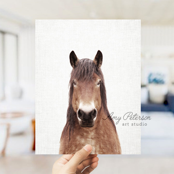 a person holding up a picture of a horse