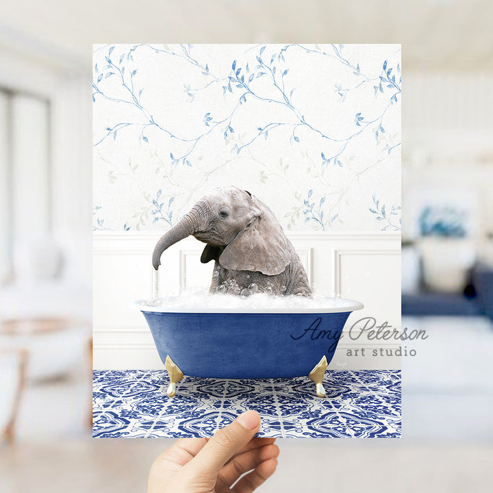 a person holding up a card with an elephant in a bathtub