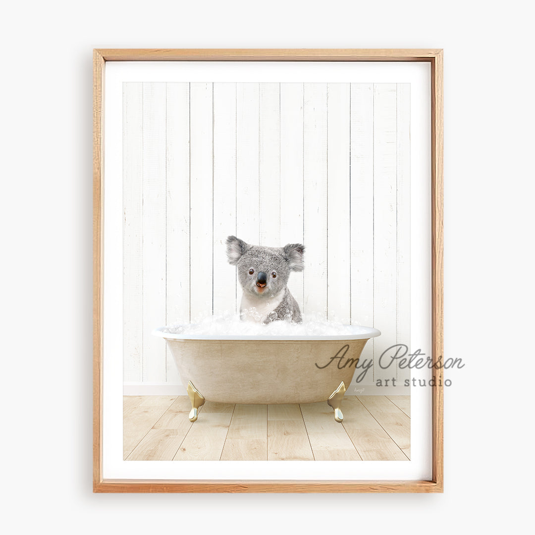 a framed picture of a koala in a bathtub