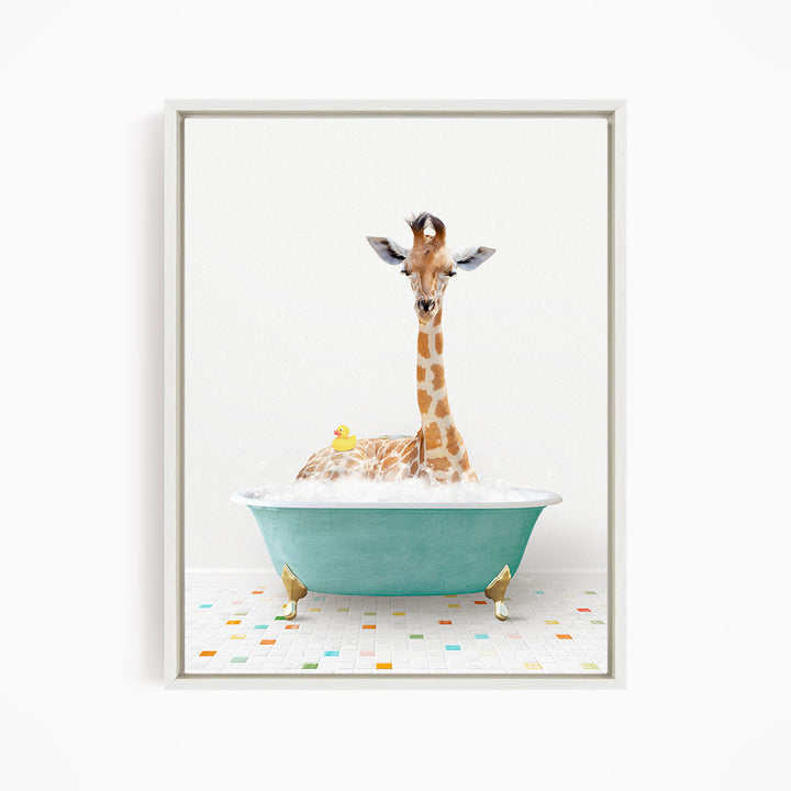 A giraffe is sitting in a green bathtub filled with bubbles, with a yellow rubber duck floating nearby.