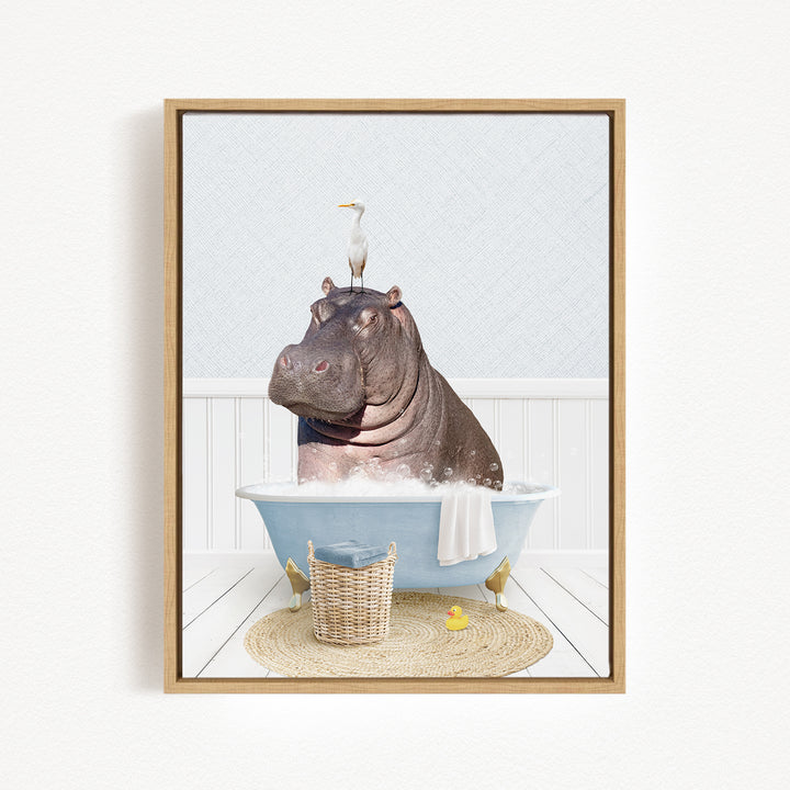 A hippopotamus sitting in a bathtub, with a bird perched on its head, and a basket of rubber ducks nearby.