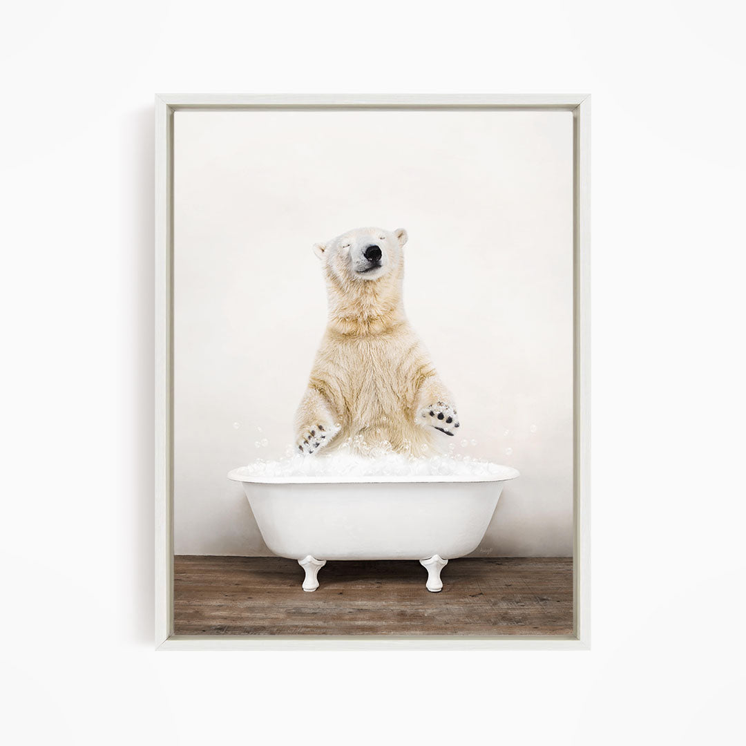 A polar bear standing in a white bathtub filled with water, with its paws raised in the air.