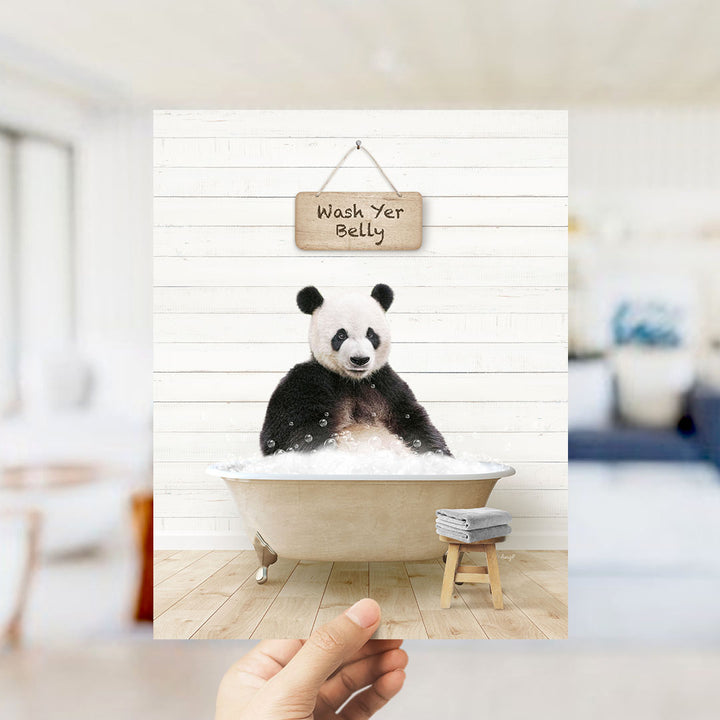 A panda bear sitting in a bathtub with a sign that says "Wash Yer Belly" above it.