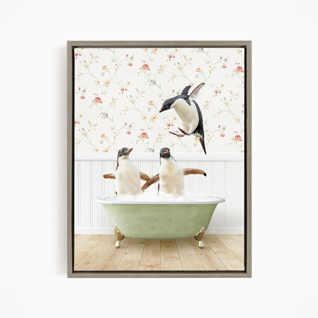 A framed image depicting two penguins sitting in a green bathtub, with one penguin flying towards the other in mid-air.