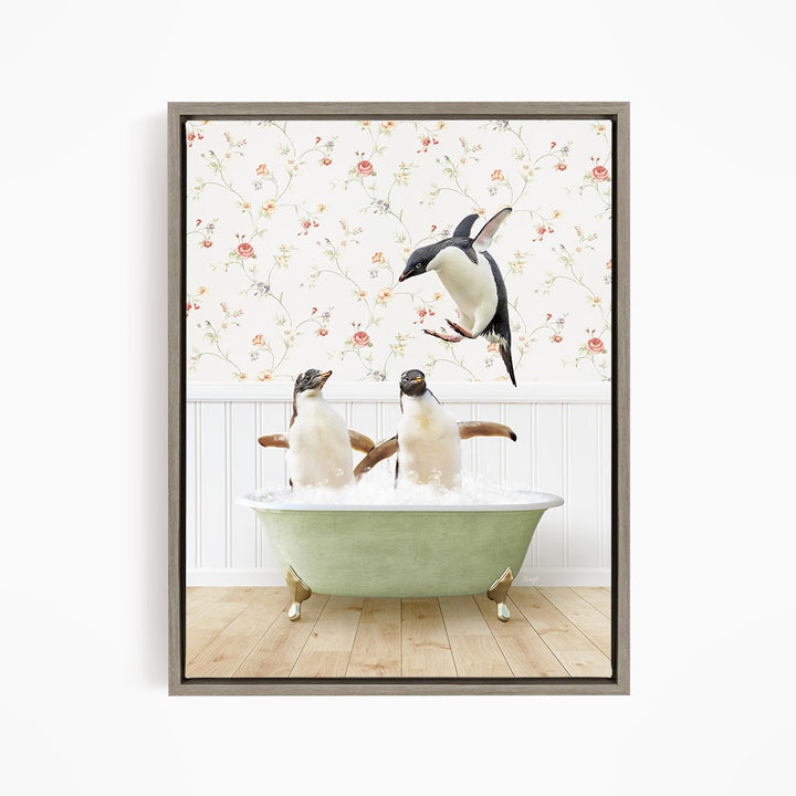 A framed image depicting two penguins sitting in a green bathtub, with one penguin flying towards the other in mid-air.