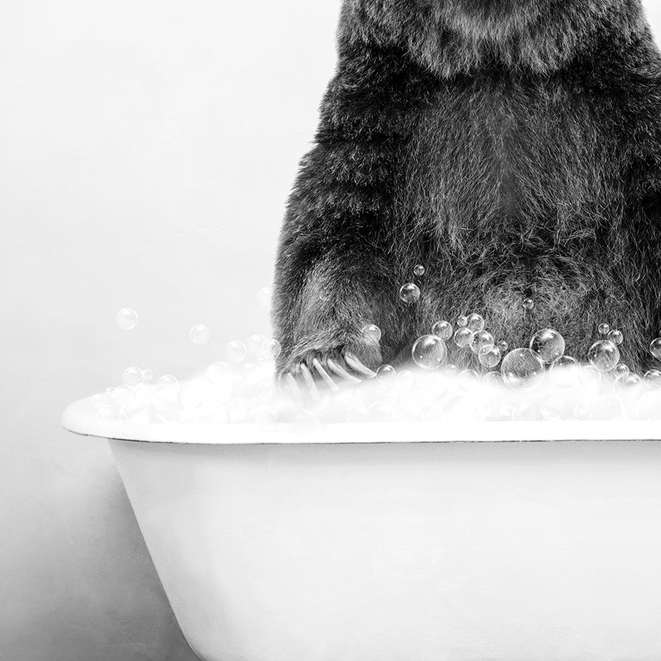 a black and white photo of a bear in a bathtub