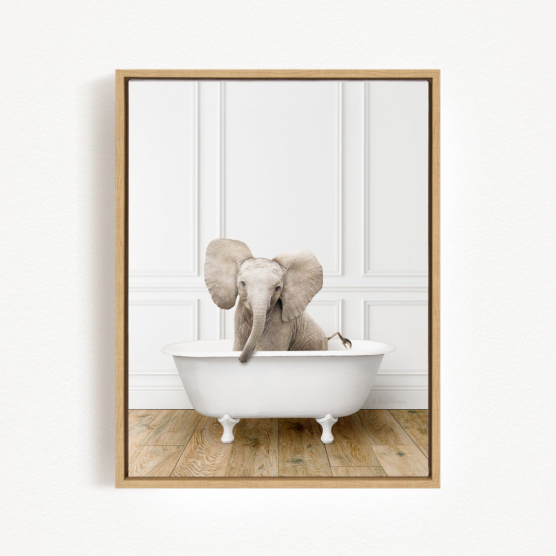 A baby elephant sitting in a white bathtub, with its trunk raised and ears flapping, against a white background.