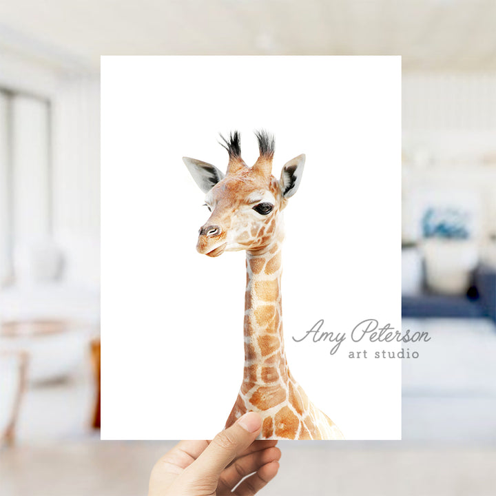 a hand holding a card with a picture of a giraffe