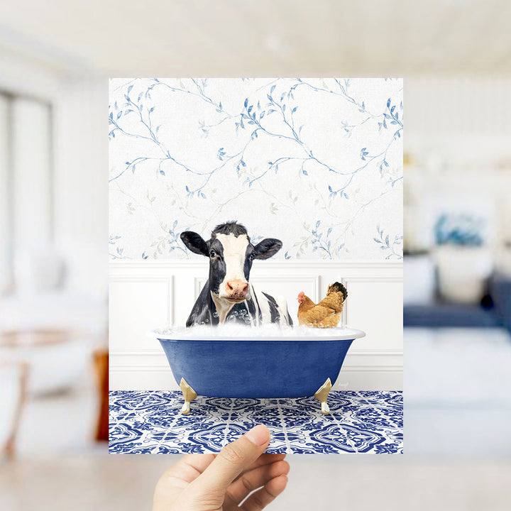 A cow and a chicken are sitting in a blue bathtub, with the cow appearing to be enjoying the bath.