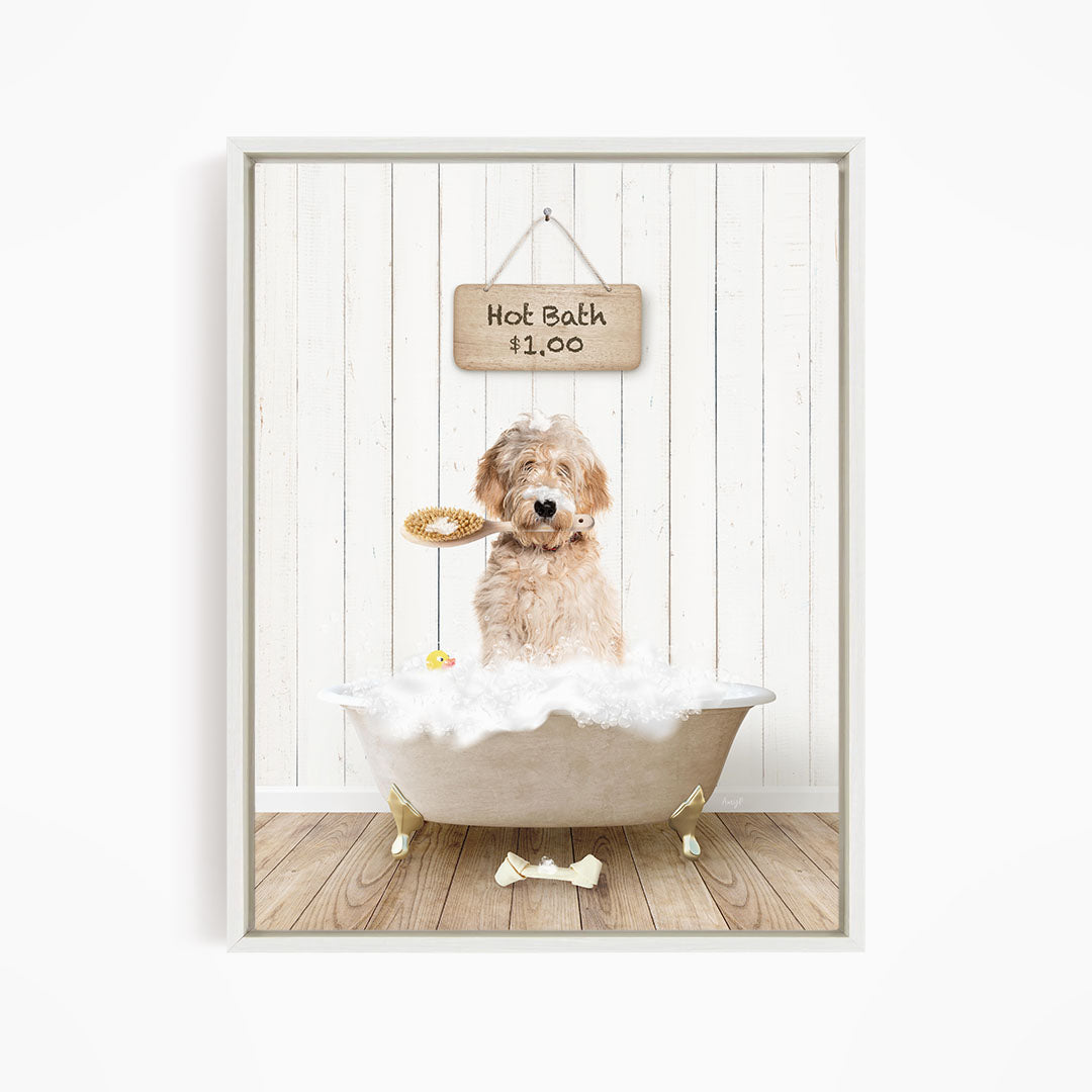 A dog is sitting in a white bathtub filled with bubbles, holding a toy in its mouth, with a sign above the tub indicating a hot bath for $11.00.