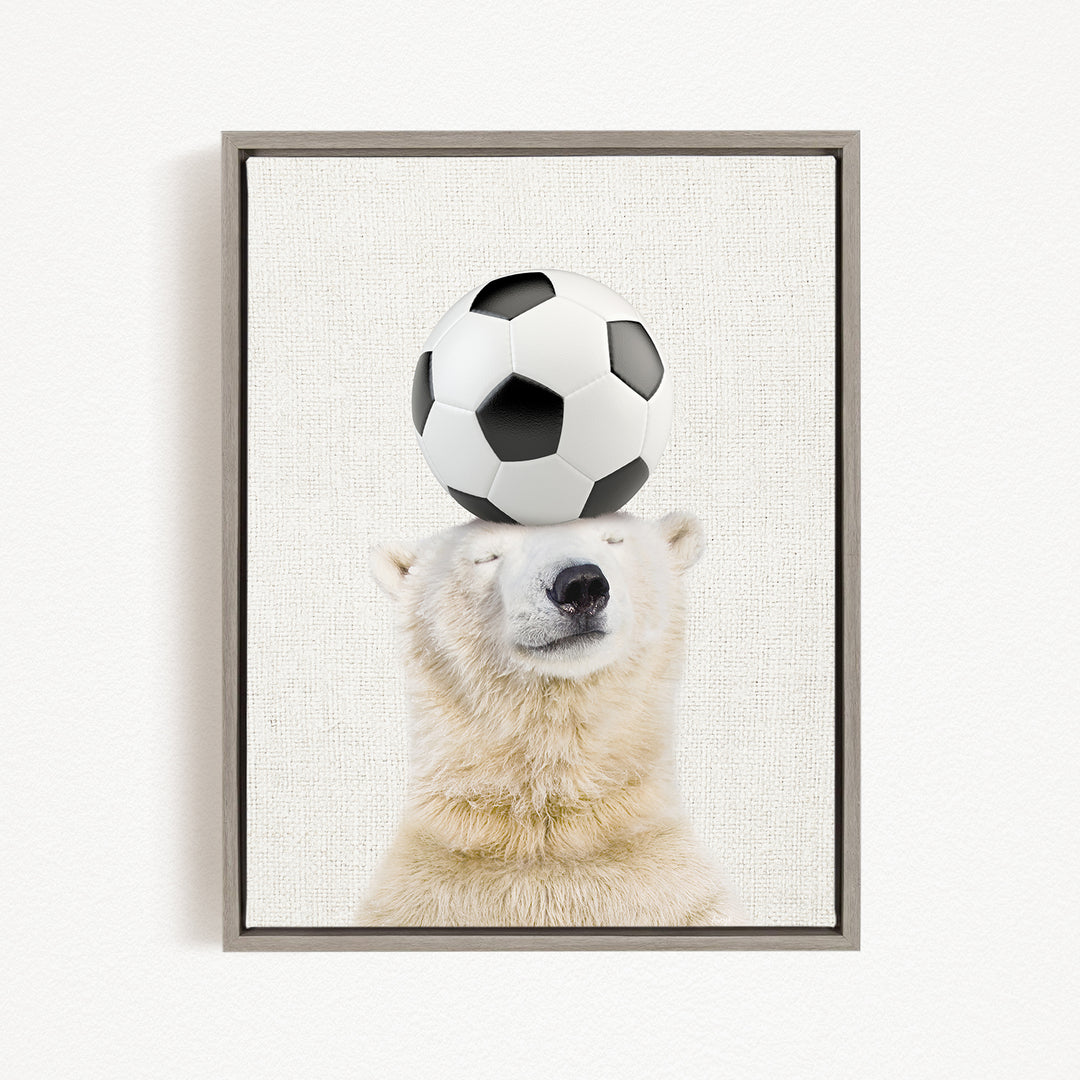 A polar bear balancing a soccer ball on its head.