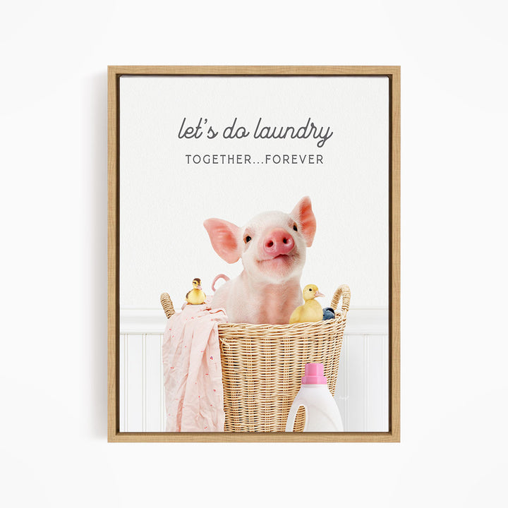 A cute pig sitting in a wicker basket filled with toys, accompanied by the text "let's do laundry together forever".