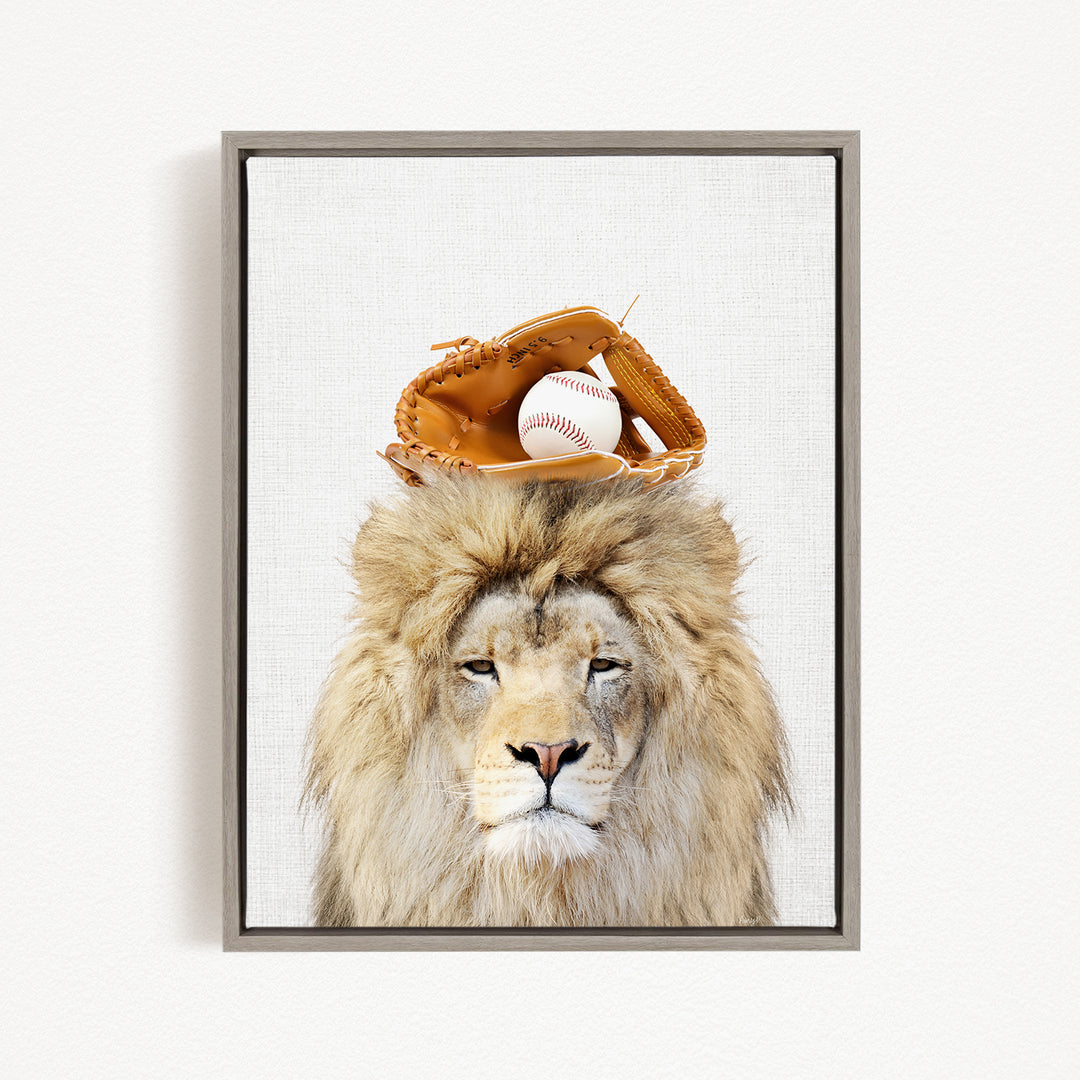 A lion with a baseball glove on its head, with a baseball visible inside the glove.
