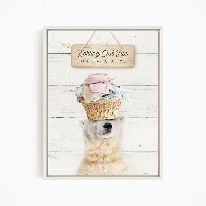 A polar bear balancing a basket of laundry on its head, with a sign above that says "Sorting Out Life One Load at a Time".