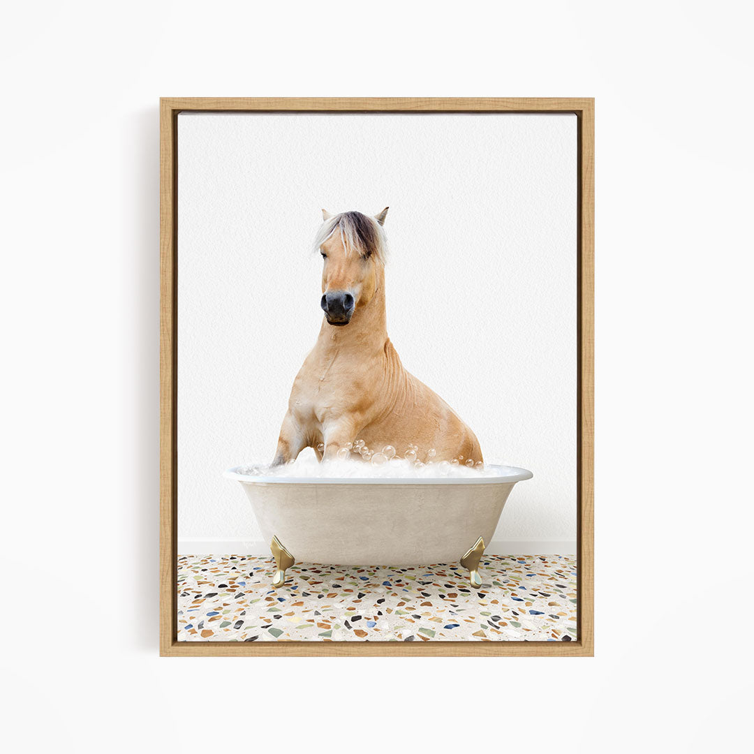 A light brown horse is sitting in a white bathtub filled with water, creating a whimsical and playful scene.