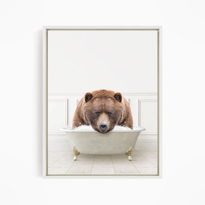 A brown bear is sitting in a white bathtub filled with water, appearing to be enjoying a relaxing bath.