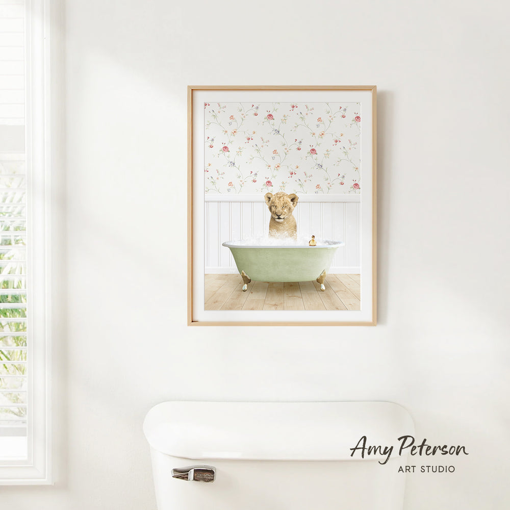 A framed print of a dog sitting in a bathtub, surrounded by a floral pattern, hangs on a white wall above a white toilet.