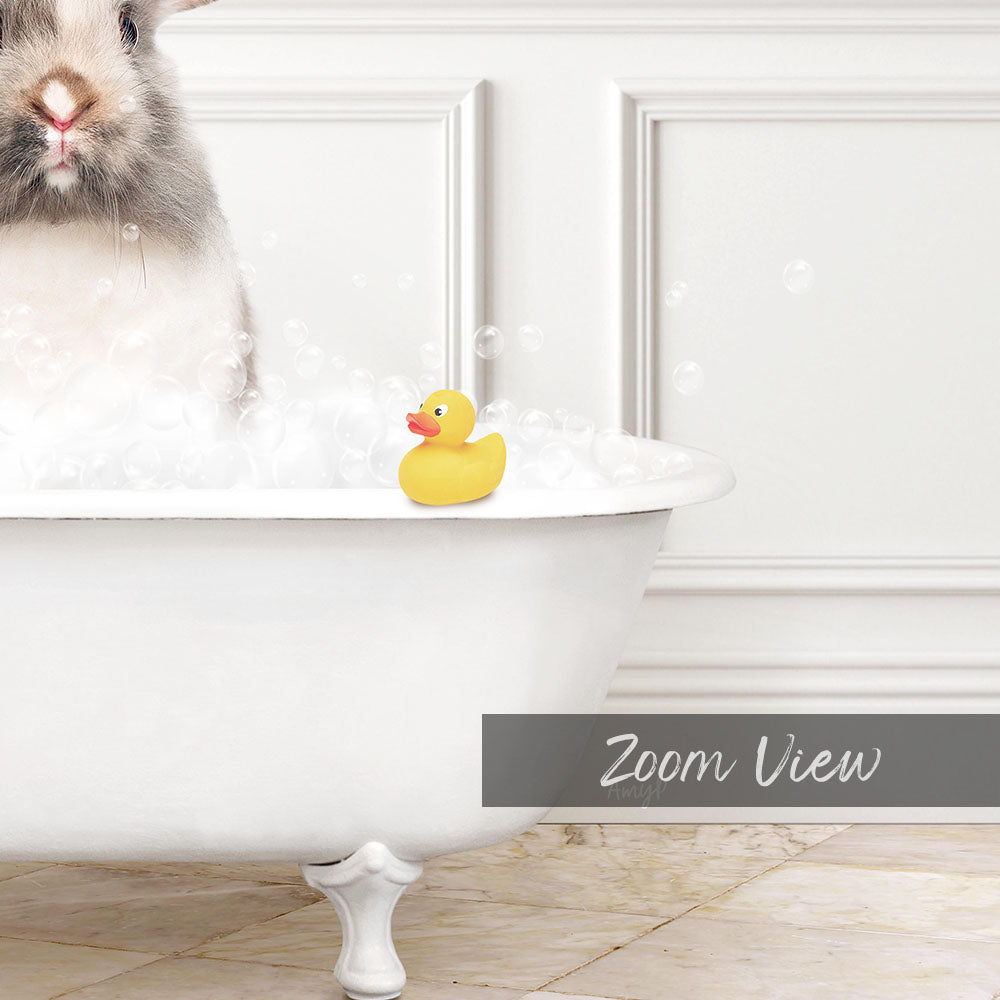 A white bathtub filled with bubbles, with a yellow rubber duck sitting on the edge.