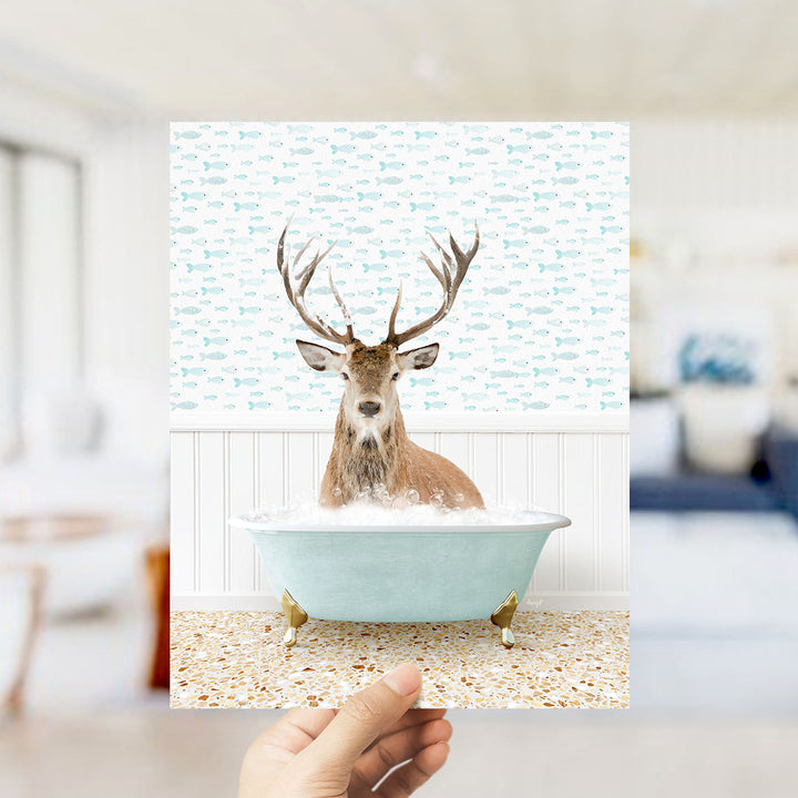 A deer with antlers is sitting in a bathtub filled with bubbles, surrounded by a pattern of fish.