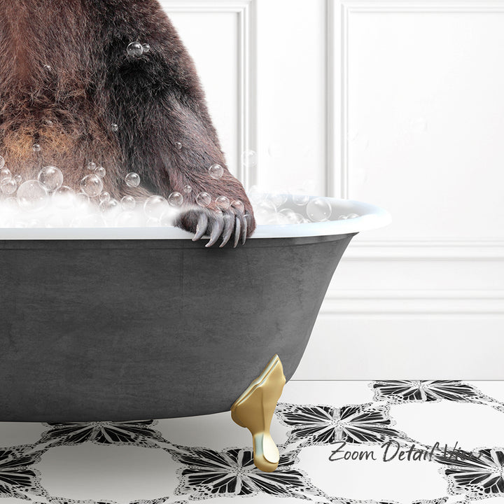A close-up of a bear's paw resting on the edge of a bathtub filled with bubbles, with a gold bathtub leg visible.