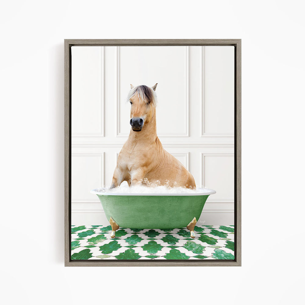 A light brown horse is sitting in a green bathtub filled with water, surrounded by a green and white patterned floor.