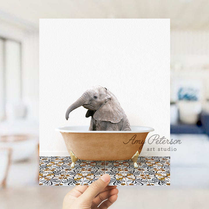 a hand holding a card with an elephant in a bathtub