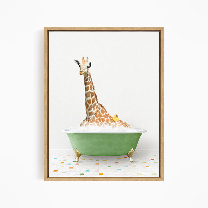 A giraffe is sitting in a green bathtub filled with bubbles, with a yellow rubber duck floating on the water.