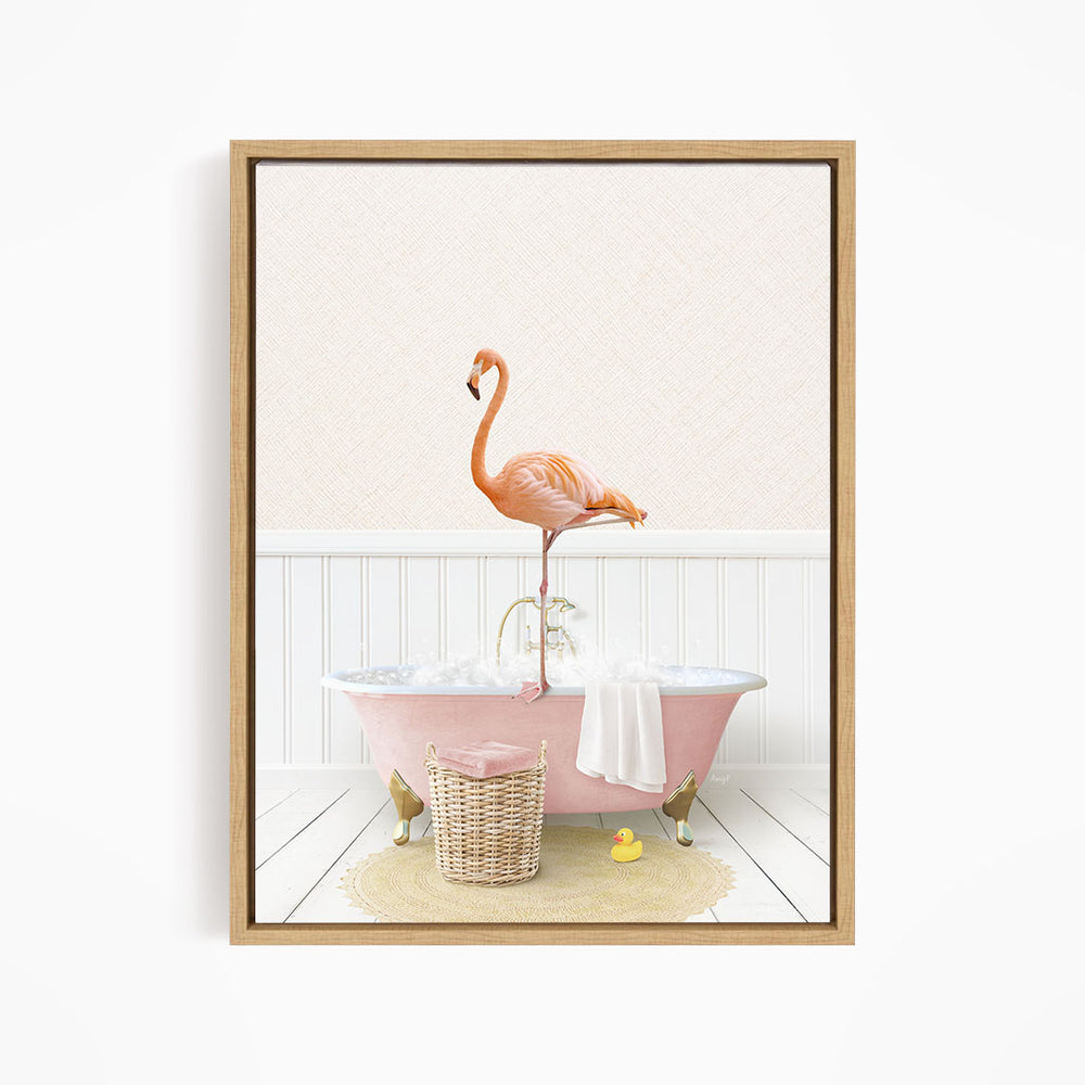 A pink flamingo stands on the edge of a pink bathtub filled with bubbles, surrounded by a yellow rubber duck and a wicker basket.
