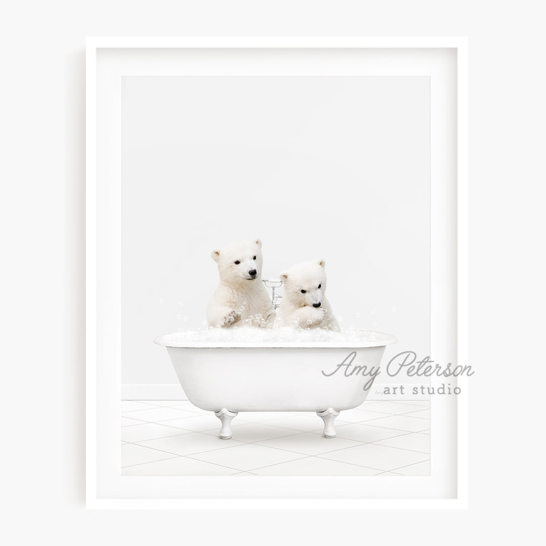 two polar bears are sitting in a bathtub