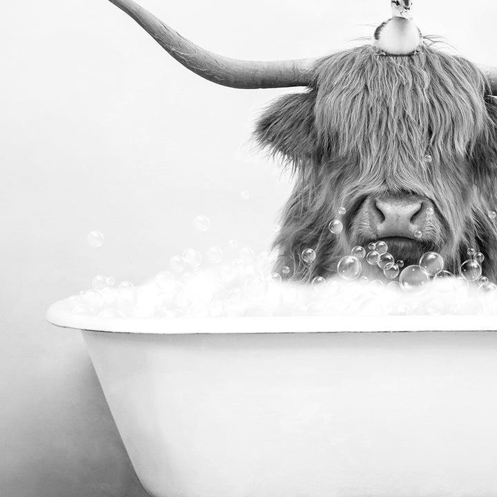 a cow with long horns sitting in a bathtub