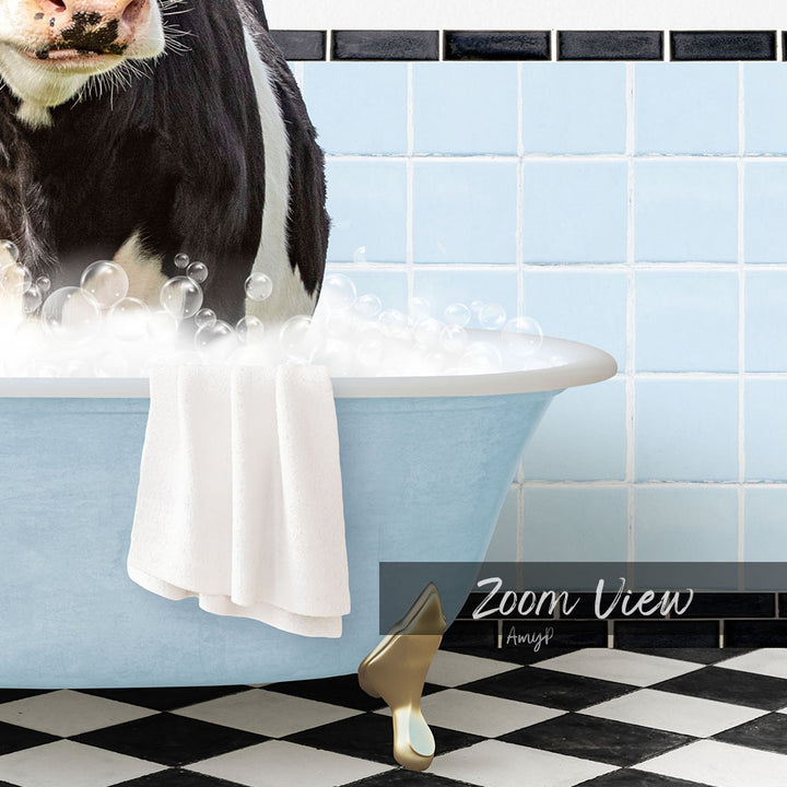 A black and white cow is sitting in a blue bathtub filled with bubbles, with a towel draped over its back and a checkered floor in the background.